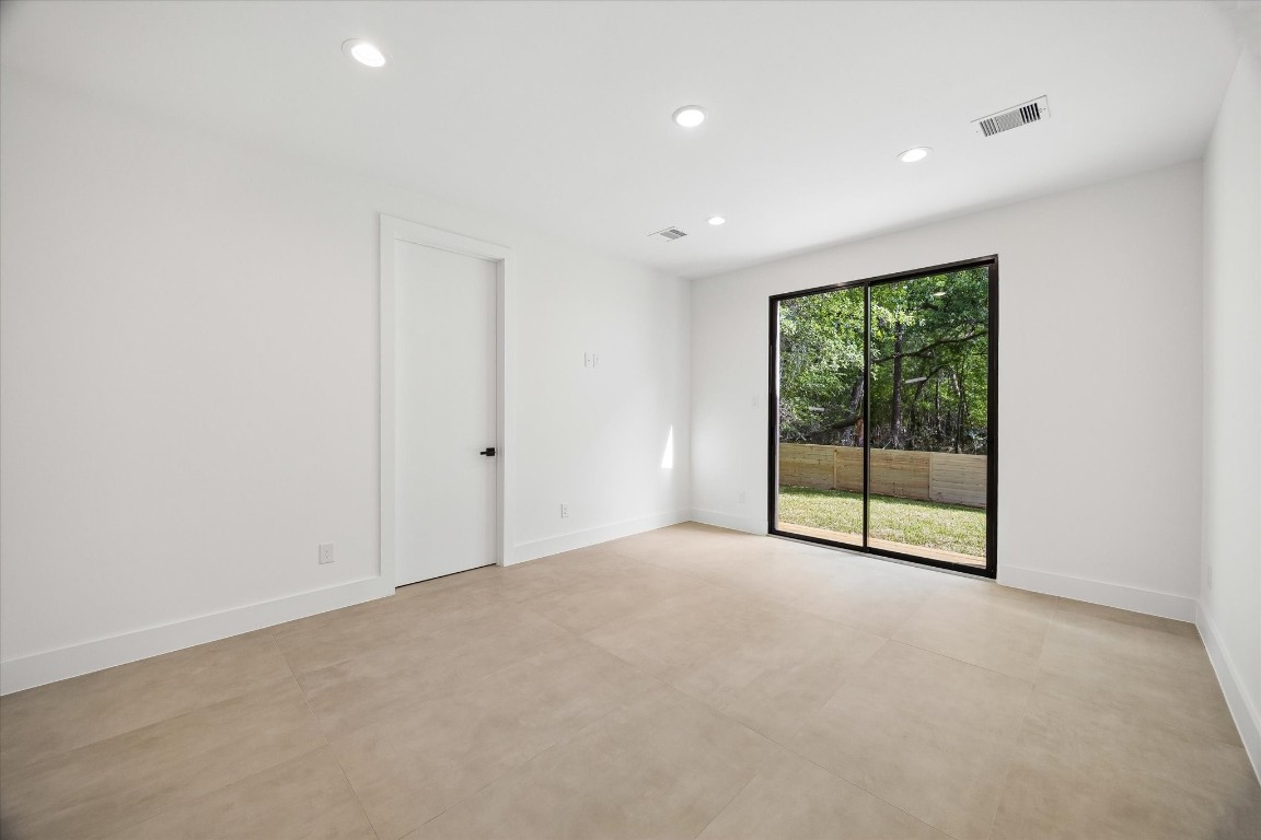 10943 Mockingbird Place Conroe, TX 77385 - Photo 9 of 24 an empty room with sliding glass door and shower