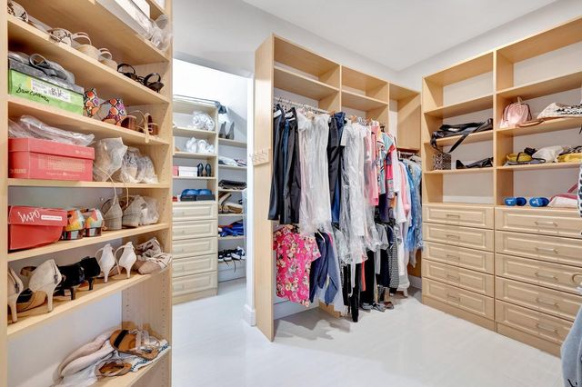 a bathroom with a double vanity sink mirror and toilet