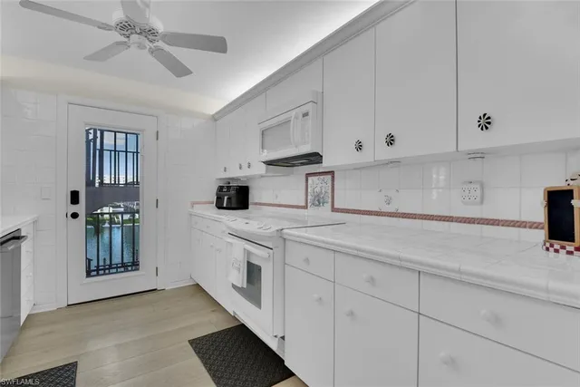 a kitchen with stainless steel appliances granite countertop a sink and a stove