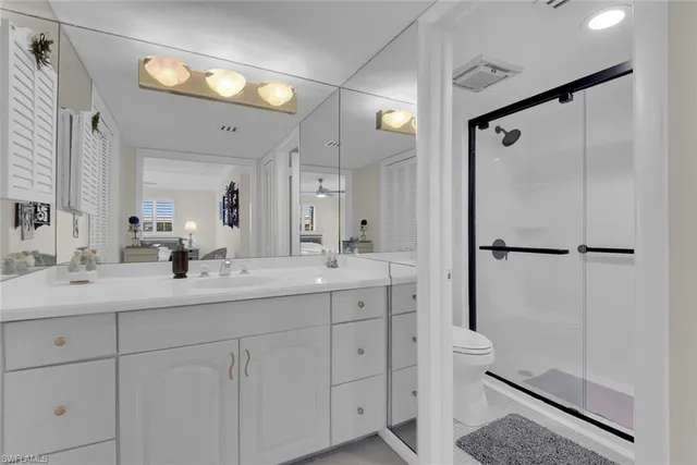 a bathroom with a double vanity sink mirror and shower