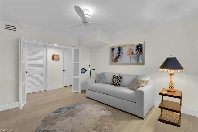 a living room with furniture and a lamp