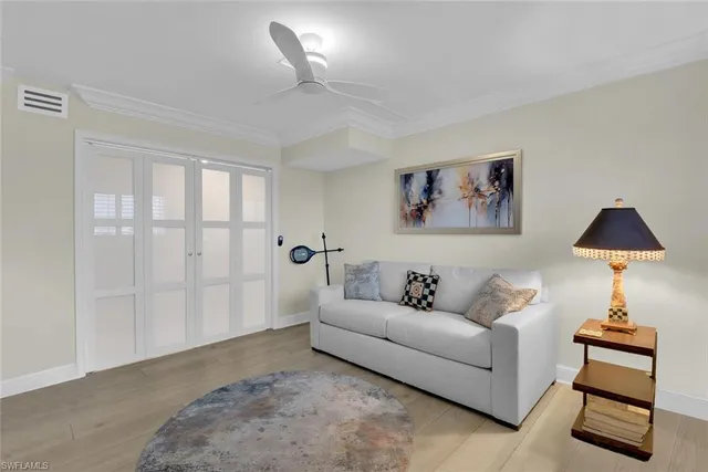 a living room with furniture a couch and a chandelier