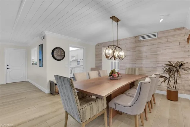 a view of a dining room with furniture and chandelier