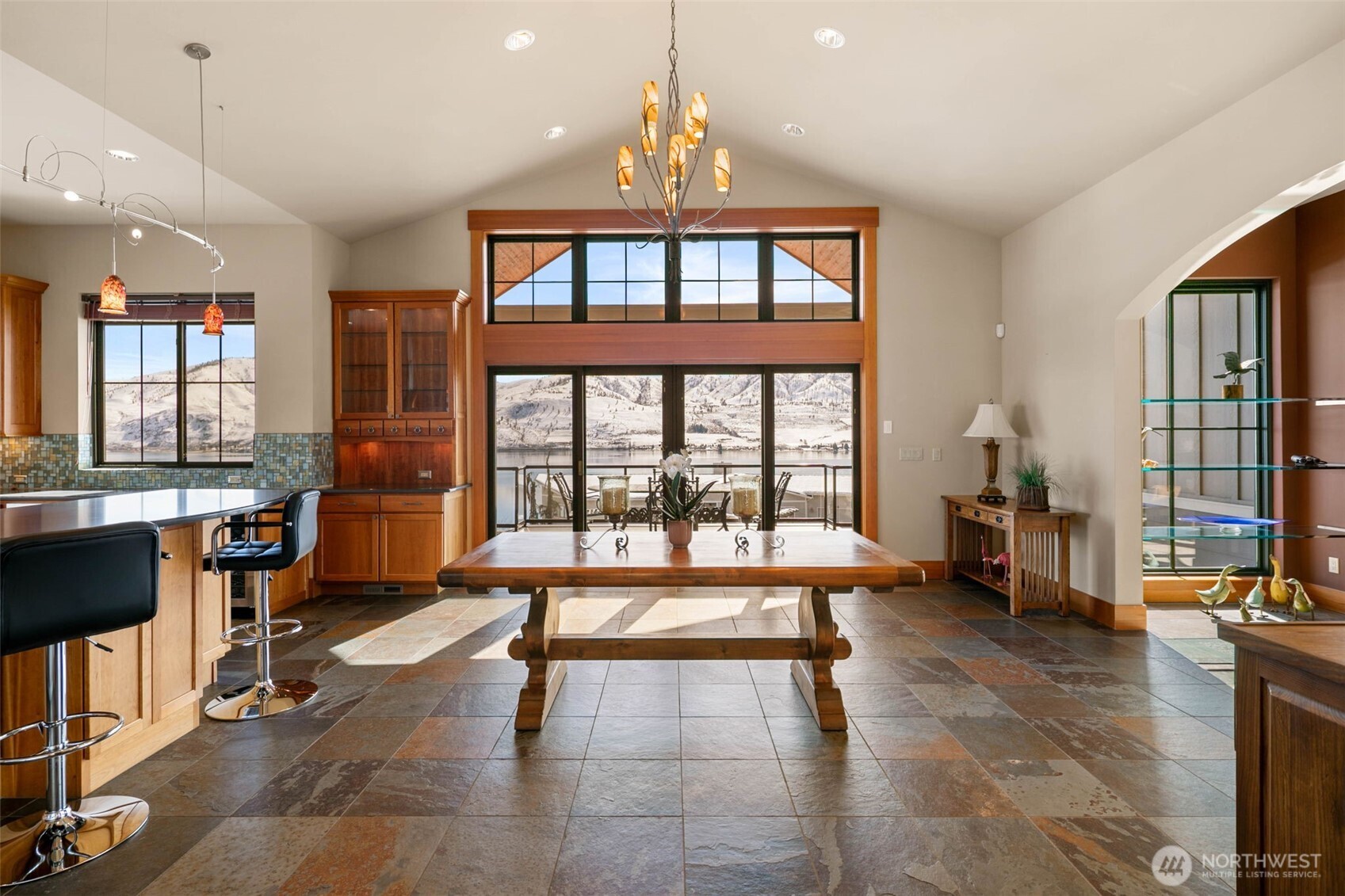 232 Crystal Drive Chelan, WA 98816 - Photo 12 of 39 a living room filled with furniture a chandelier and a floor to ceiling window