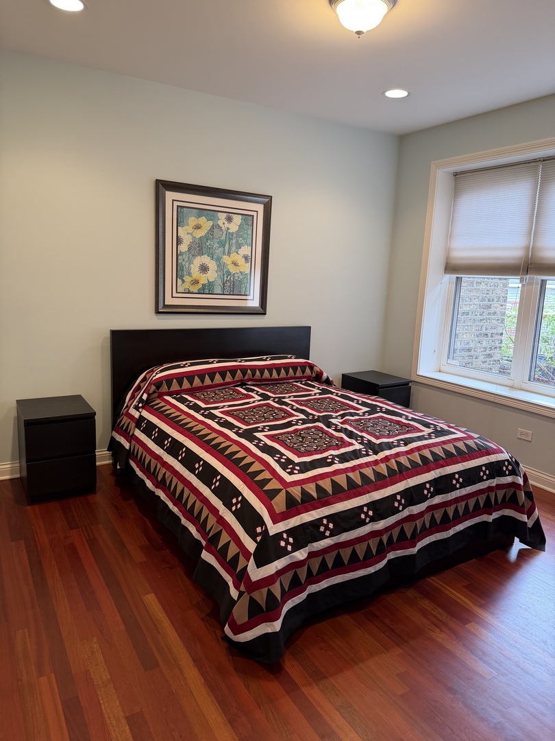 4546 North Spaulding Avenue, Unit 1 Chicago, IL 60625 - Photo 12 of 22 a bedroom with a bed and wooden floor