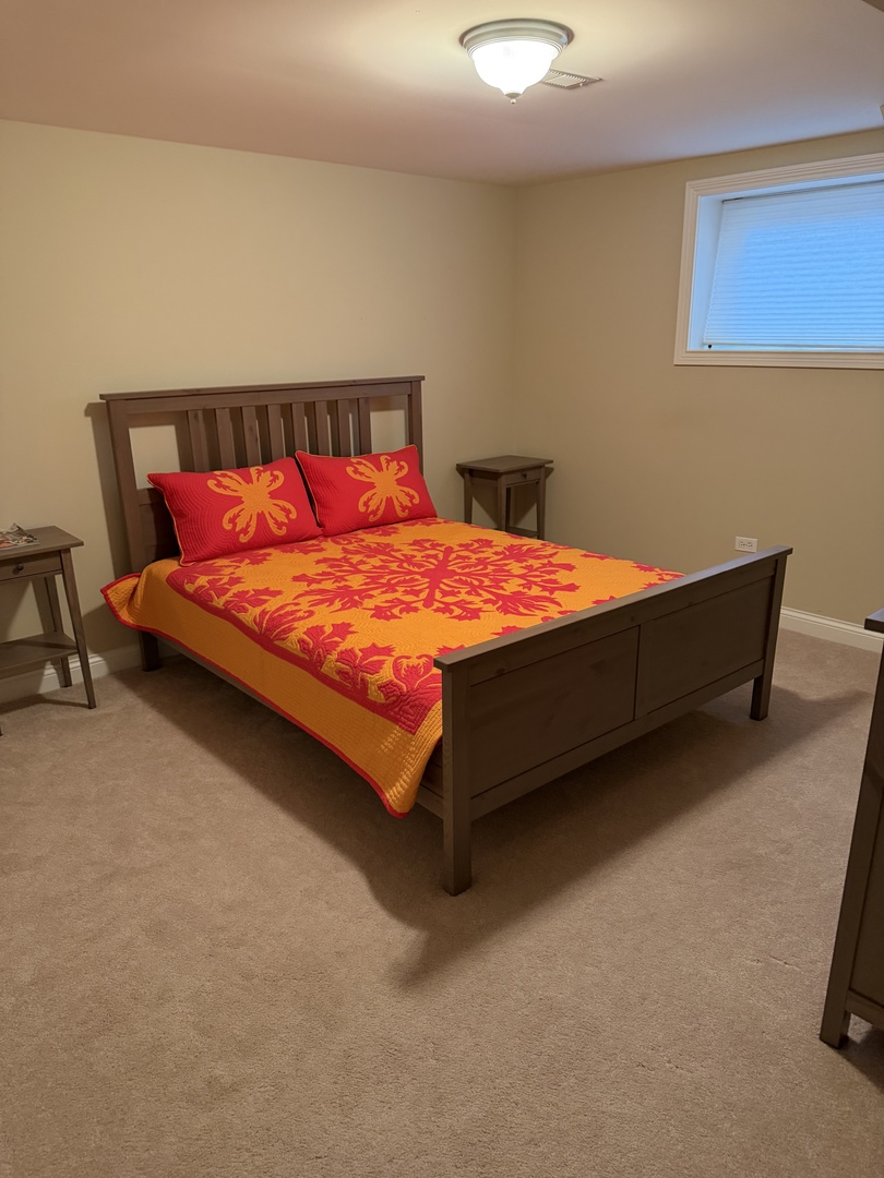 4546 North Spaulding Avenue, Unit 1 Chicago, IL 60625 - Photo 16 of 22 a bed sitting in a bedroom next to a chair