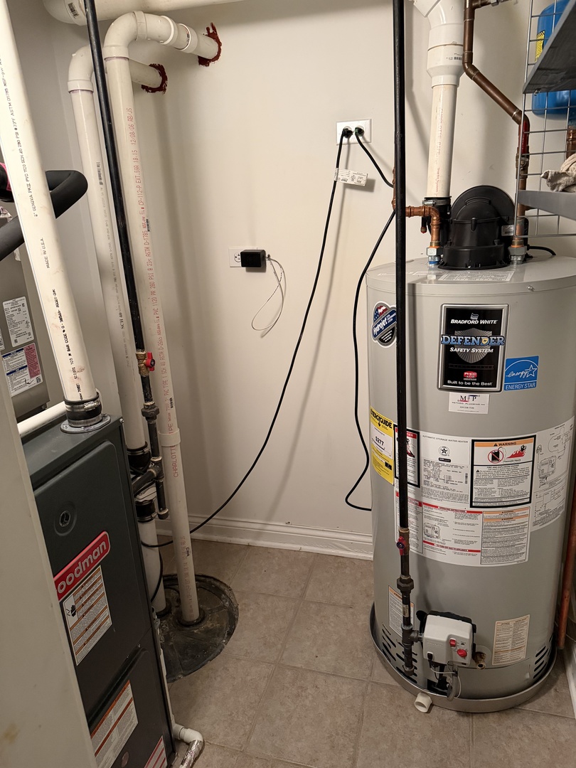 4546 North Spaulding Avenue, Unit 1 Chicago, IL 60625 - Photo 22 of 22 a room with water heater and a wooden floor