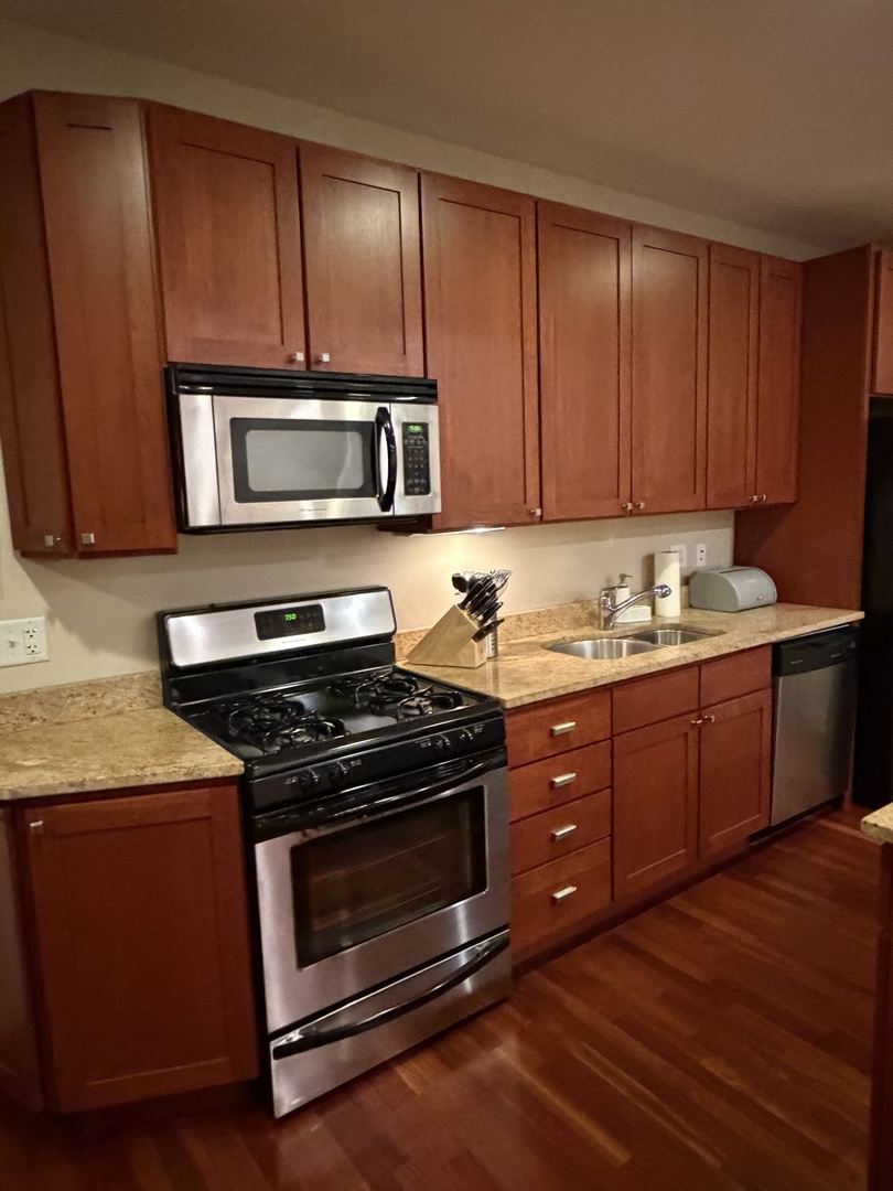 4546 North Spaulding Avenue, Unit 1 Chicago, IL 60625 - Photo 5 of 22 a kitchen with wooden cabinets and a stove top oven