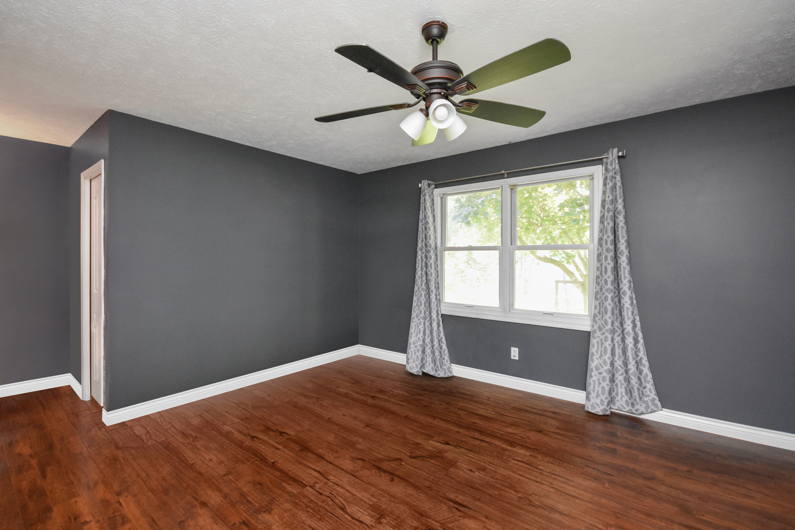 604 Morningside Drive Chenoa, IL 61726 - Photo 13 of 33 a view of a big room with wooden floor and windows