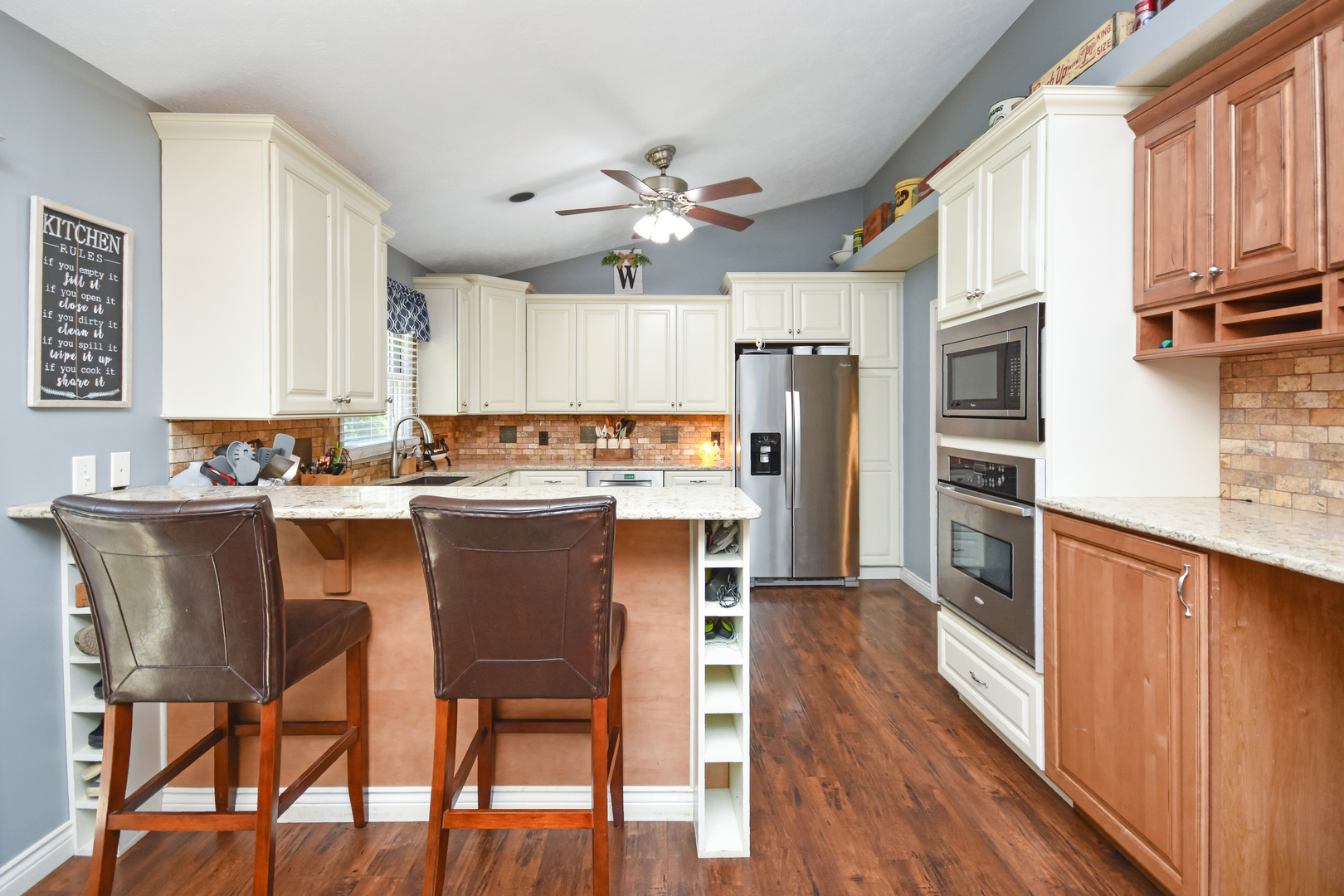 604 Morningside Drive Chenoa, IL 61726 - Photo 4 of 33 a kitchen with stainless steel appliances granite countertop a refrigerator a stove microwave and island with wooden floor