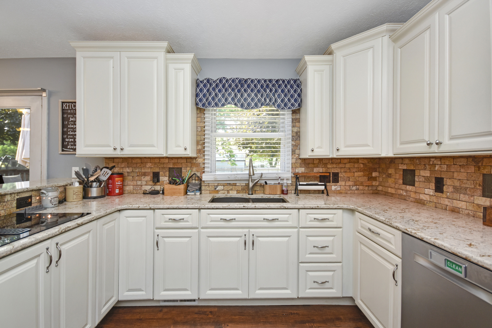 604 Morningside Drive Chenoa, IL 61726 - Photo 6 of 33 a kitchen with granite countertop white cabinets and white appliances