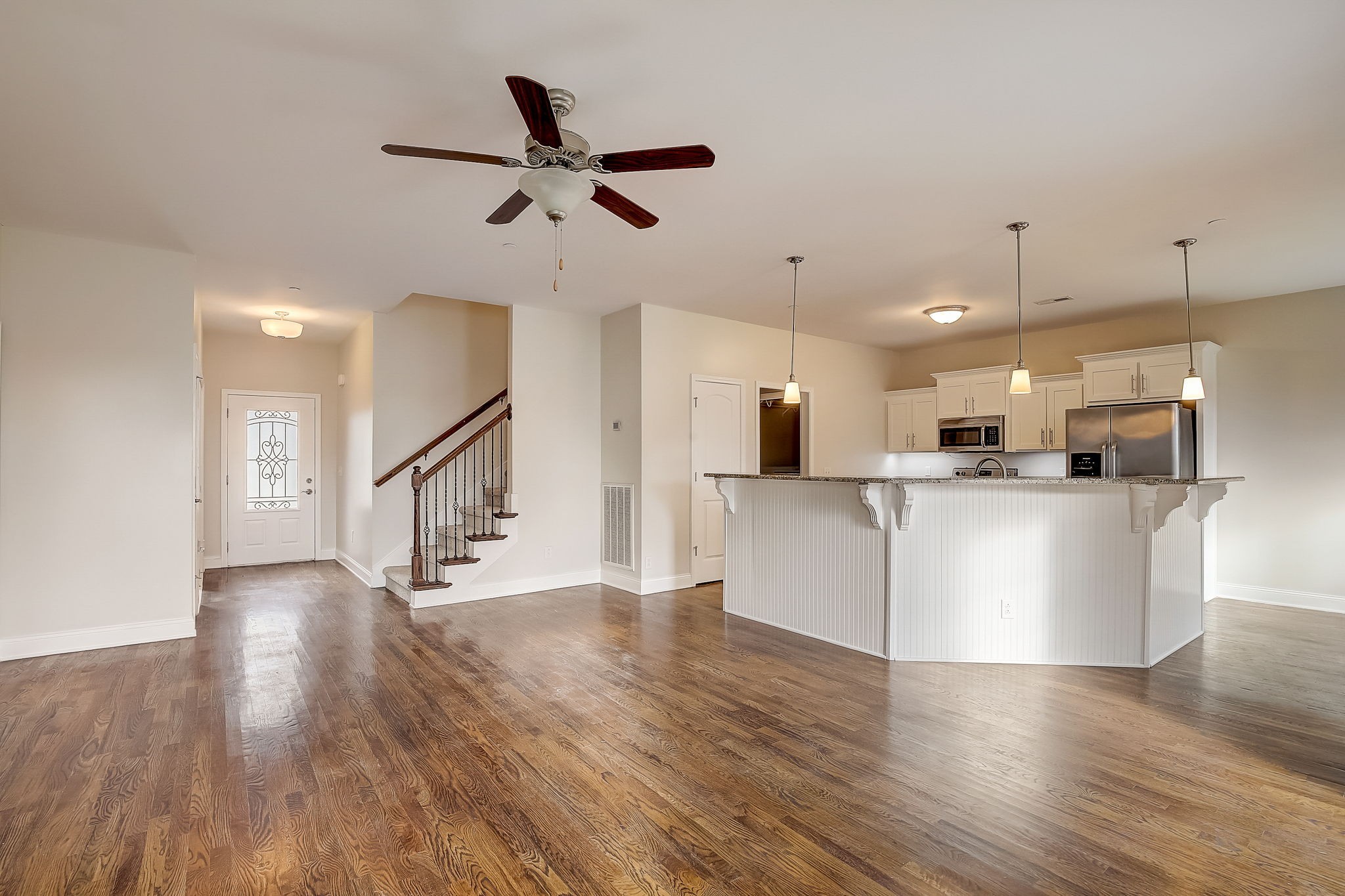 1028 Grace Road Pleasant View, TN 37015 - Photo 2 of 21 a view of an empty room and kitchen with wooden floor