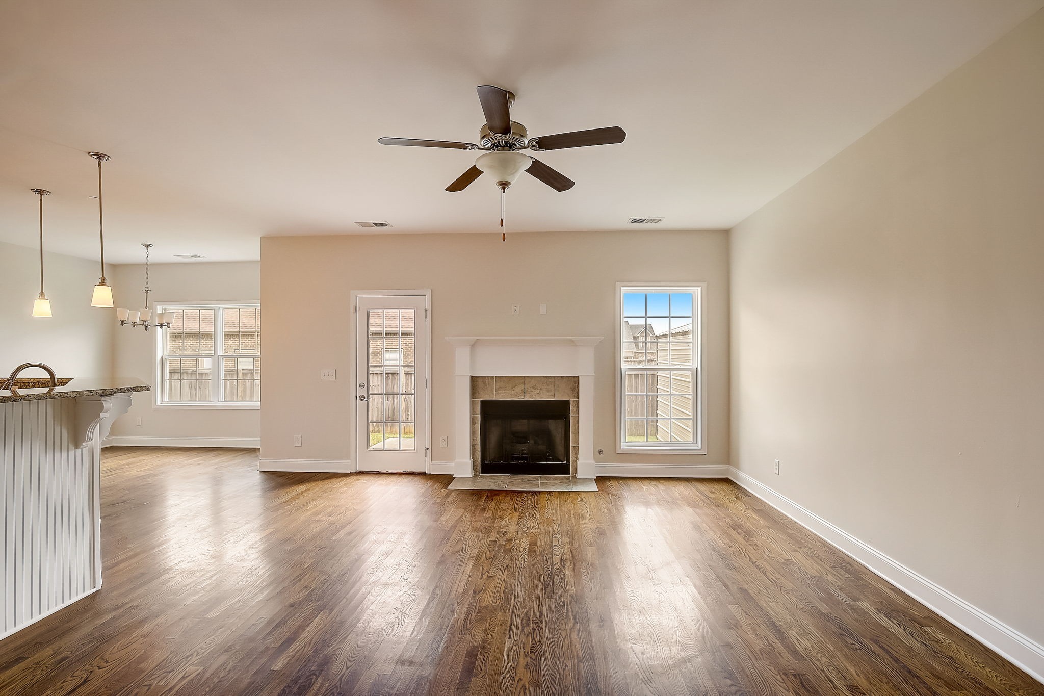 1028 Grace Road Pleasant View, TN 37015 - Photo 3 of 21 a view of a livingroom with wooden floor a ceiling fan and windows