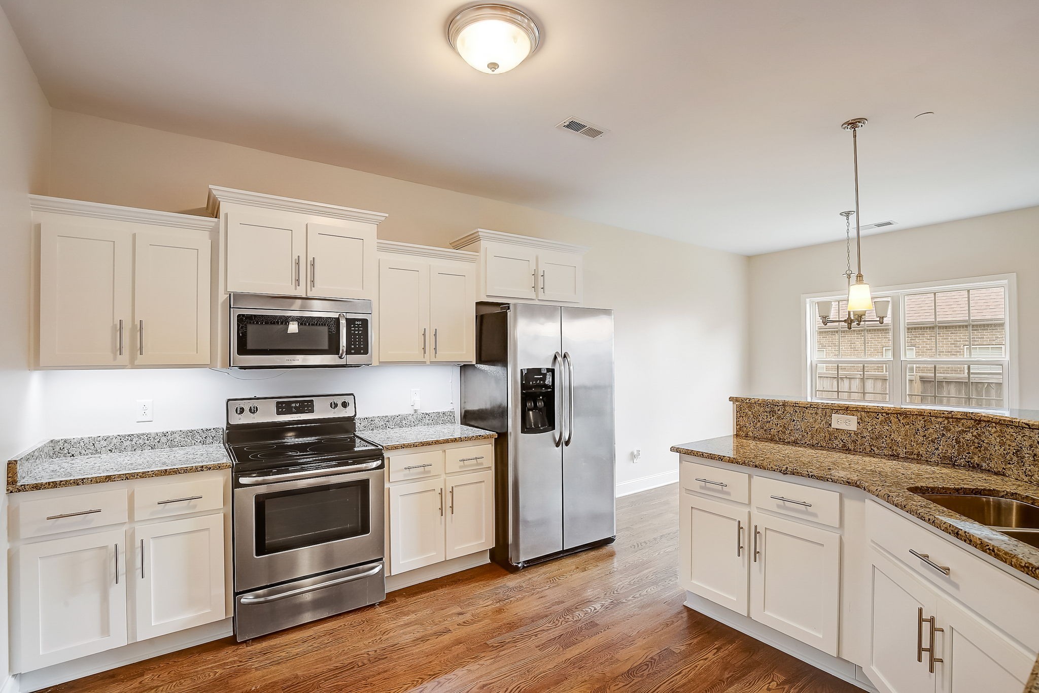 1028 Grace Road Pleasant View, TN 37015 - Photo 7 of 21 a kitchen with stainless steel appliances granite countertop a refrigerator and a stove top oven