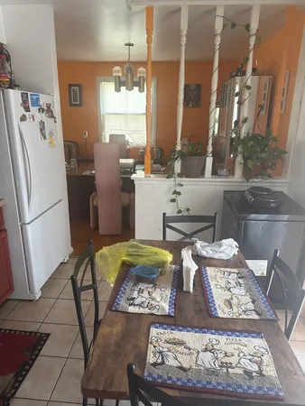 a kitchen with a stove a refrigerator and a stove top oven