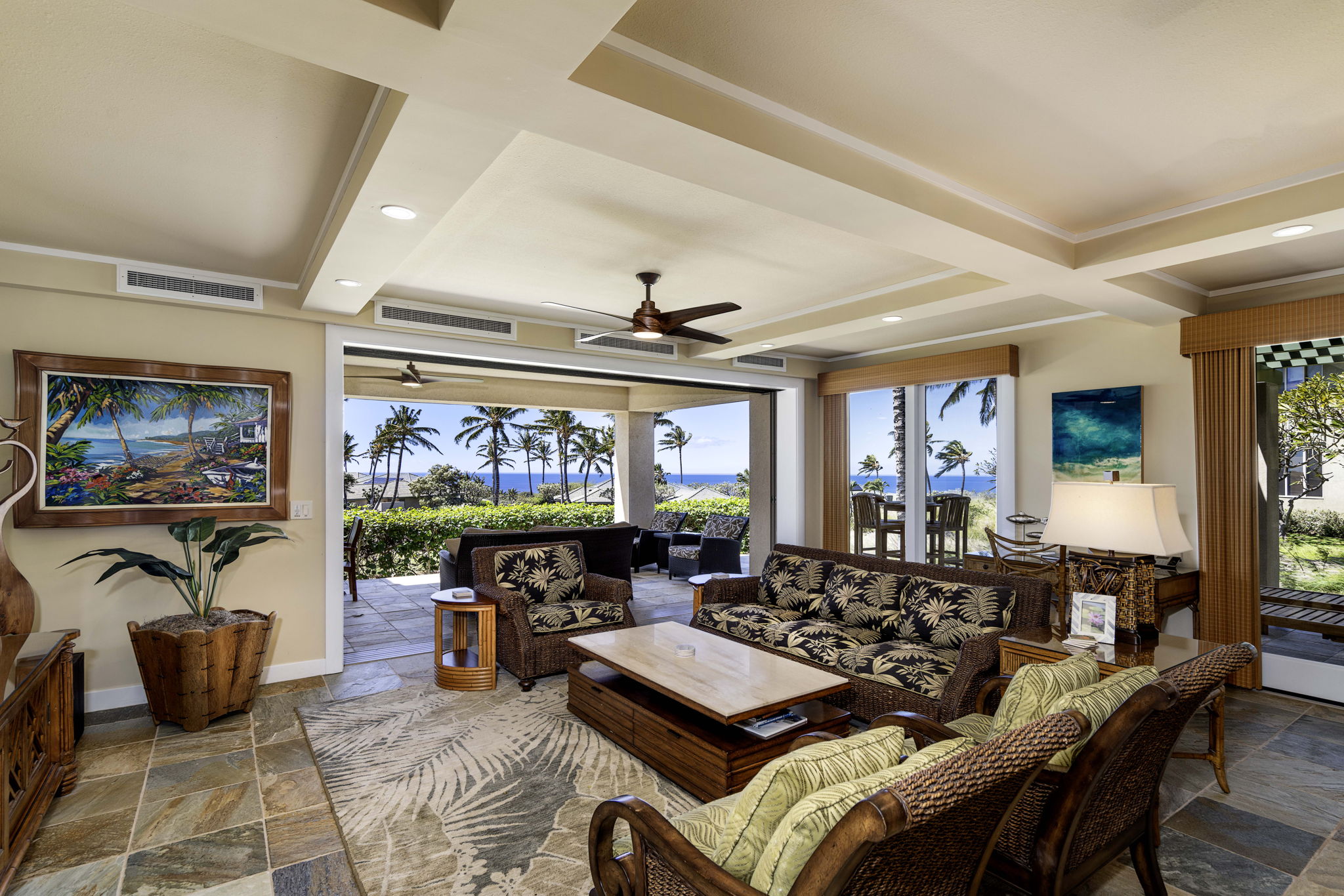62-3600 Amaui Place, Unit F102 Kamuela, HI 96743 - Photo 11 of 27 a living room with furniture a flat screen tv and a large window