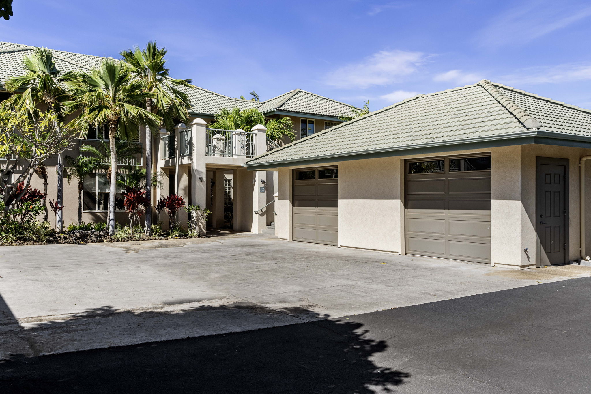 62-3600 Amaui Place, Unit F102 Kamuela, HI 96743 - Photo 19 of 27 a front view of a house with a yard and garage