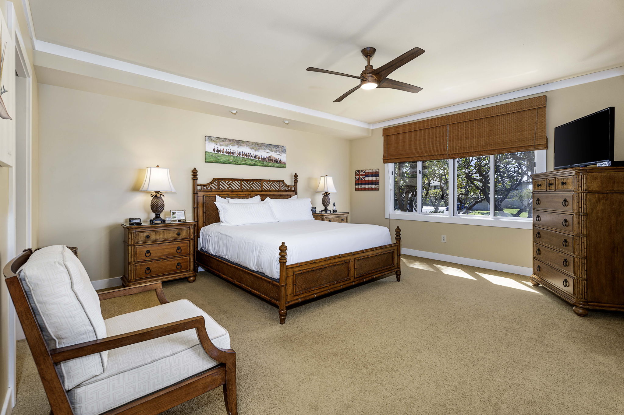 62-3600 Amaui Place, Unit F102 Kamuela, HI 96743 - Photo 2 of 27 a bedroom with a bed a flat screen tv and a couch