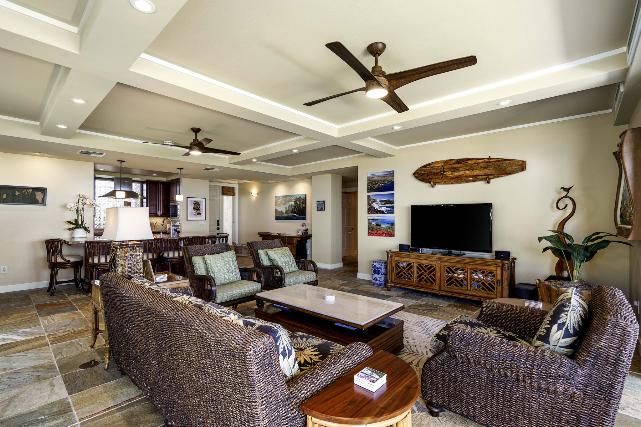 62-3600 Amaui Place, Unit F102 Kamuela, HI 96743 - Photo 8 of 27 a living room with furniture and a flat screen tv with kitchen view