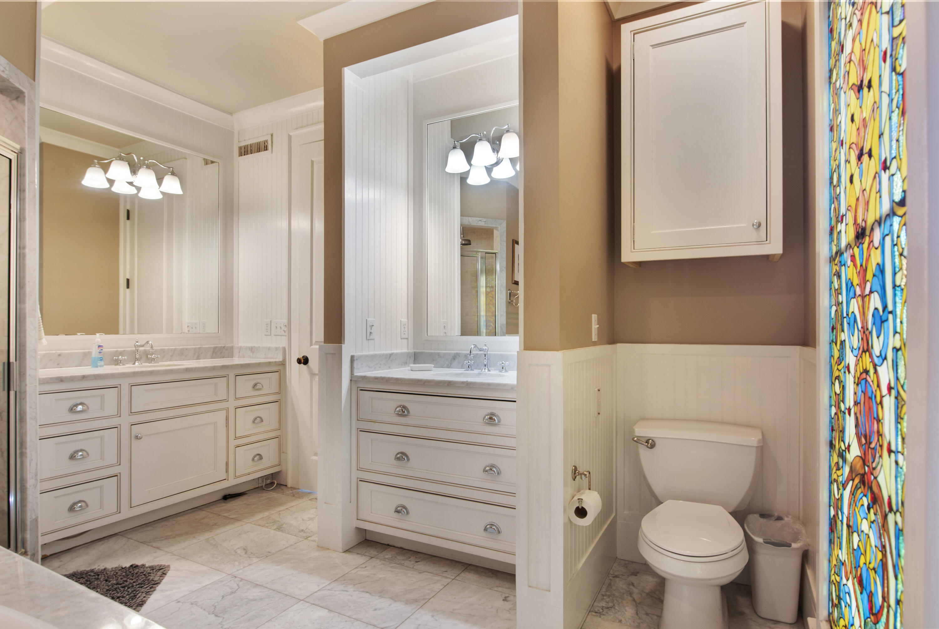 4484 Ocean View Drive Destin, FL 32541 - Photo 24 of 40 a bathroom with a granite countertop toilet sink and mirror