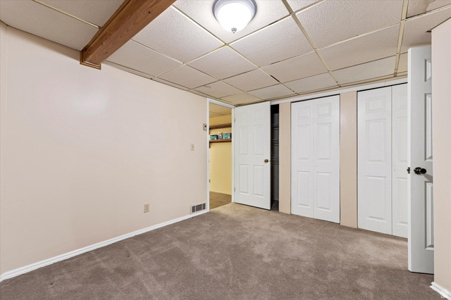 888 East 6895 South Midvale, UT 84047 - Photo 34 of 54 Comfortable lower-level bedroom with closet space and neutral finishes, ideal for guests or additional living flexibility.