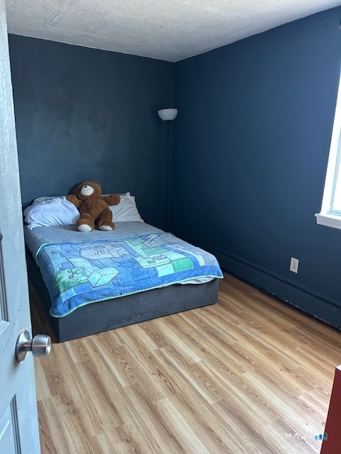 56 Angel Drive, Unit C Waterbury, CT 06708 - Photo 6 of 10 a bed sitting in a bedroom next to a window