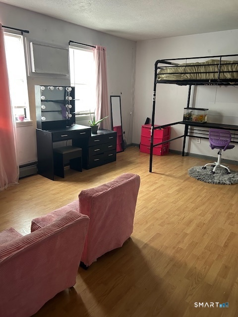 56 Angel Drive, Unit C Waterbury, CT 06708 - Photo 7 of 10 a living room with furniture and a flat screen tv