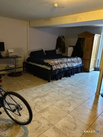 a bedroom with a bed and a night stand