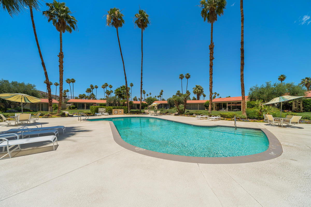 76895 Lark Drive Indian Wells, CA 92210 - Photo 8 of 25 a view of a swimming pool with a table and chairs