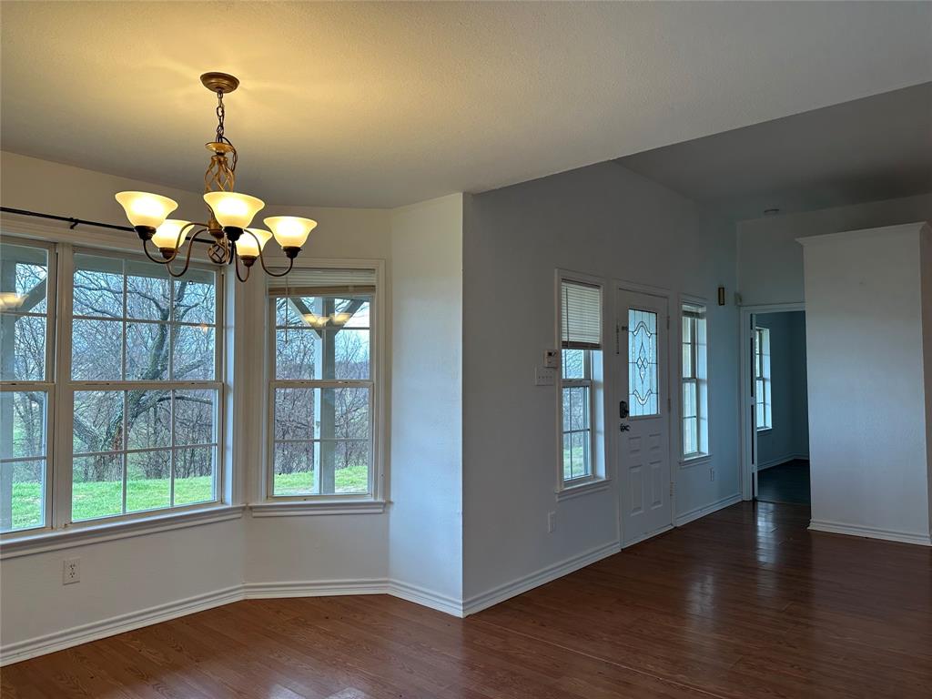 3701 Haynes Road Flower Mound, TX 76262 - Photo 7 of 12 a dining room with wooden floor chandelier and windows