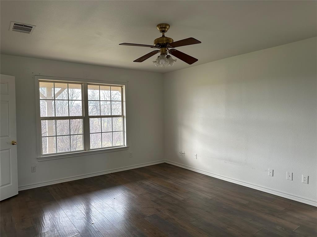 3701 Haynes Road Flower Mound, TX 76262 - Photo 10 of 12 an empty room with wooden floor fan and windows