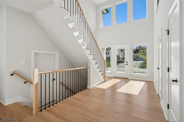 a view of a hallway with wooden floor and entryway