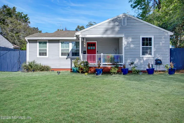 a front view of house with yard and green space
