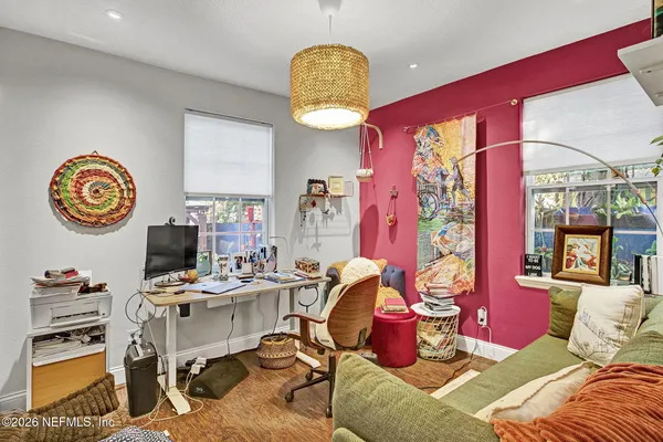 a view of a workspace with furniture and a chandelier