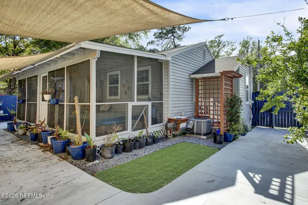 a view of a house with a yard and sitting area