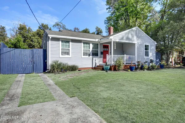 a front view of house with yard and outdoor seating