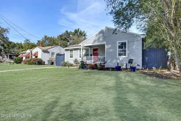 a front view of house with yard outdoor seating and green space