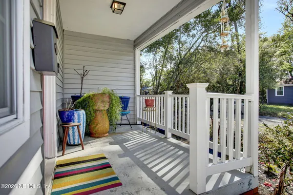 a balcony with furniture and a potted plant