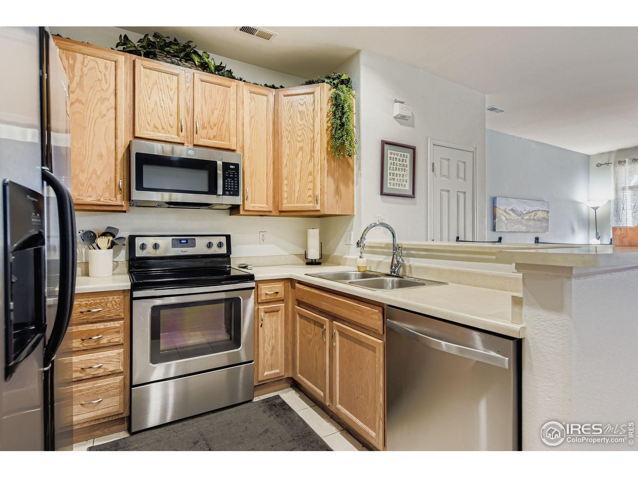 8320 Stonybridge Circle Highlands Ranch, CO 80126 - Photo 2 of 9 a kitchen with cabinets stainless steel appliances a sink and a counter space