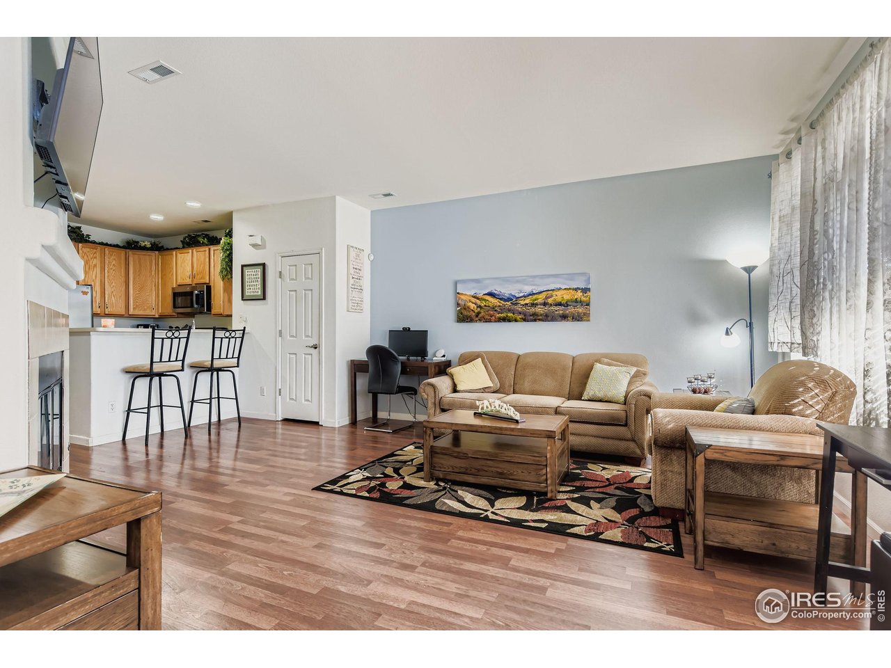 8320 Stonybridge Circle Highlands Ranch, CO 80126 - Photo 4 of 9 a living room with furniture a wooden floor and a large window