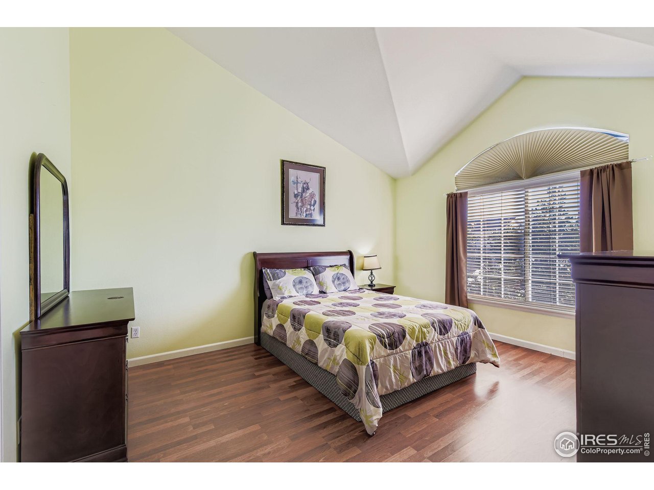 8320 Stonybridge Circle Highlands Ranch, CO 80126 - Photo 8 of 9 a bedroom with a bed and wooden floor