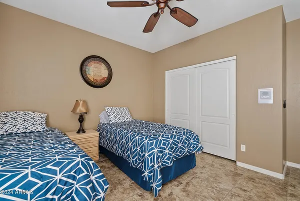 a bedroom with a large bed and a tv