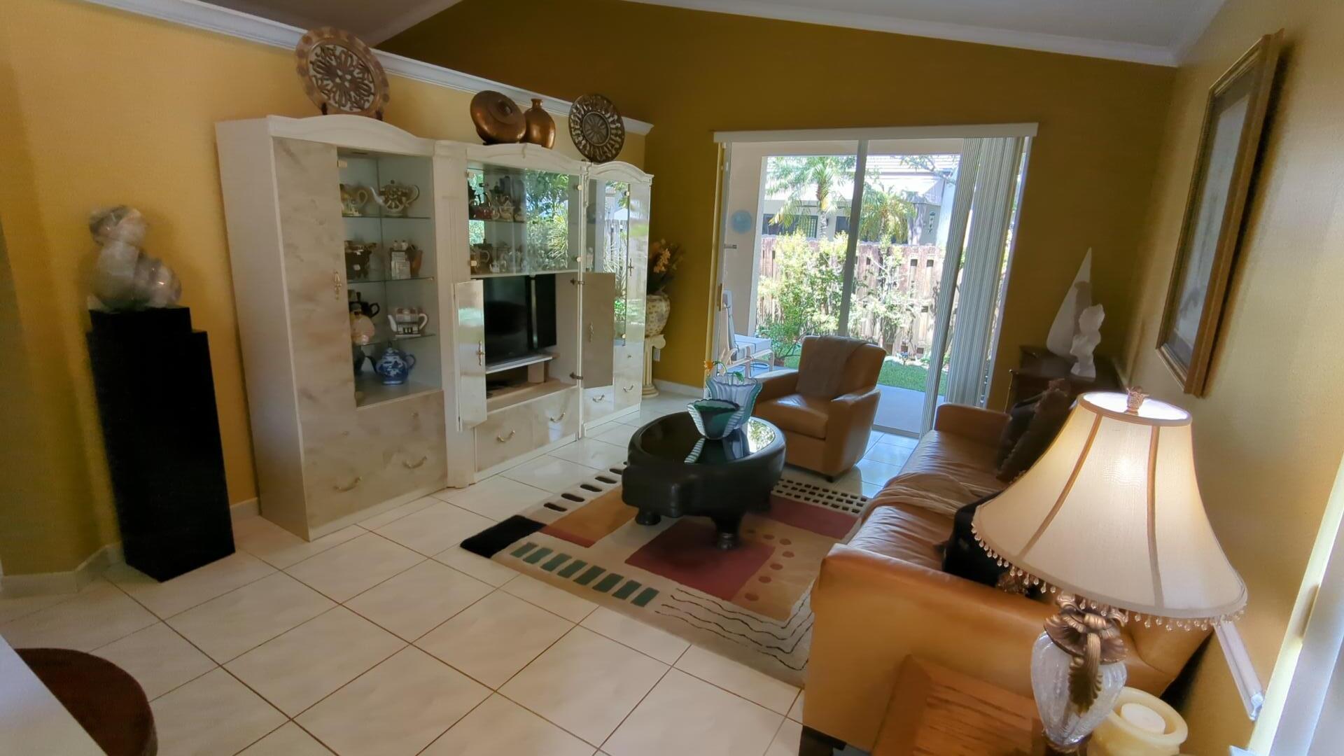 1481 Southwest 105th Avenue Pembroke Pines, FL 33025 - Photo 2 of 9 a living room with furniture and large windows