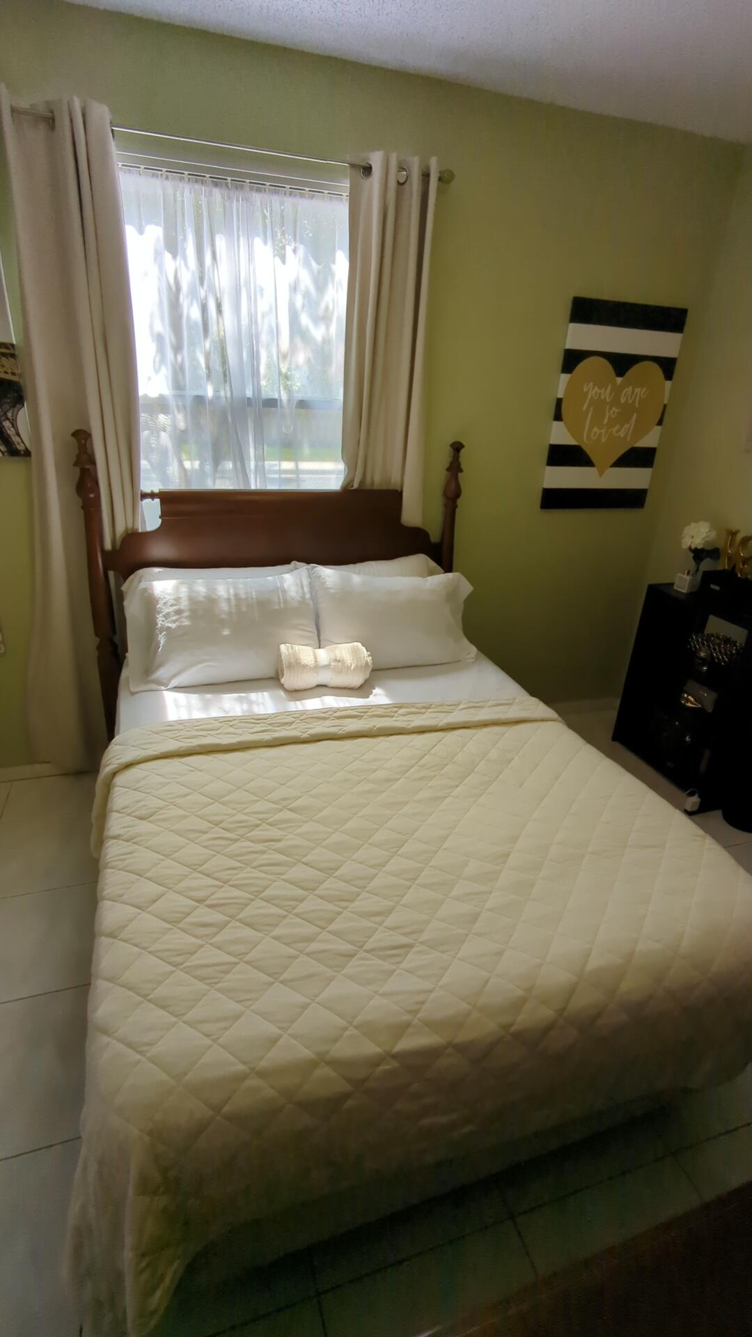 1481 Southwest 105th Avenue Pembroke Pines, FL 33025 - Photo 5 of 9 a bed sitting in a bedroom next to a window