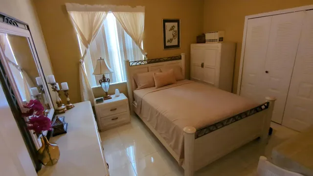 a bed room with a bed and a flat tv screen