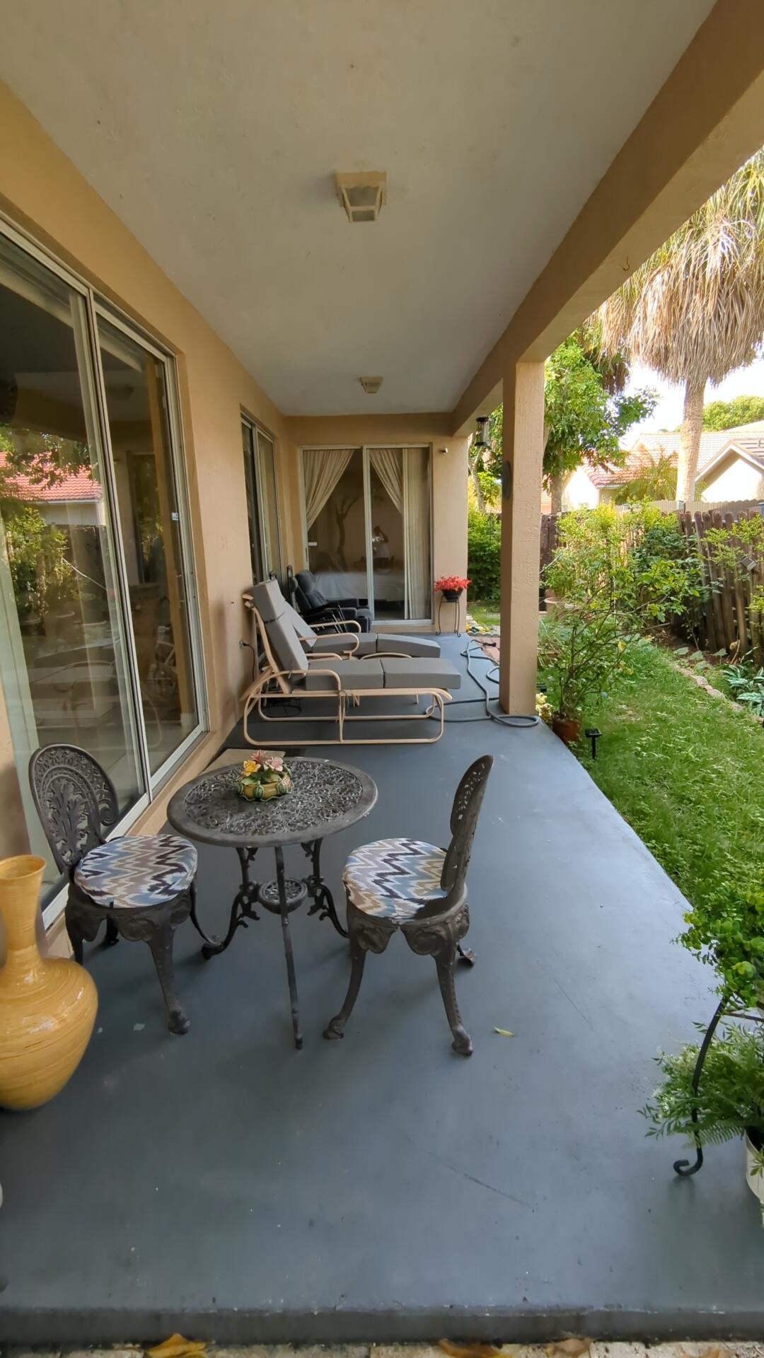1481 Southwest 105th Avenue Pembroke Pines, FL 33025 - Photo 9 of 9 a view of a patio with table and chairs next to a yard