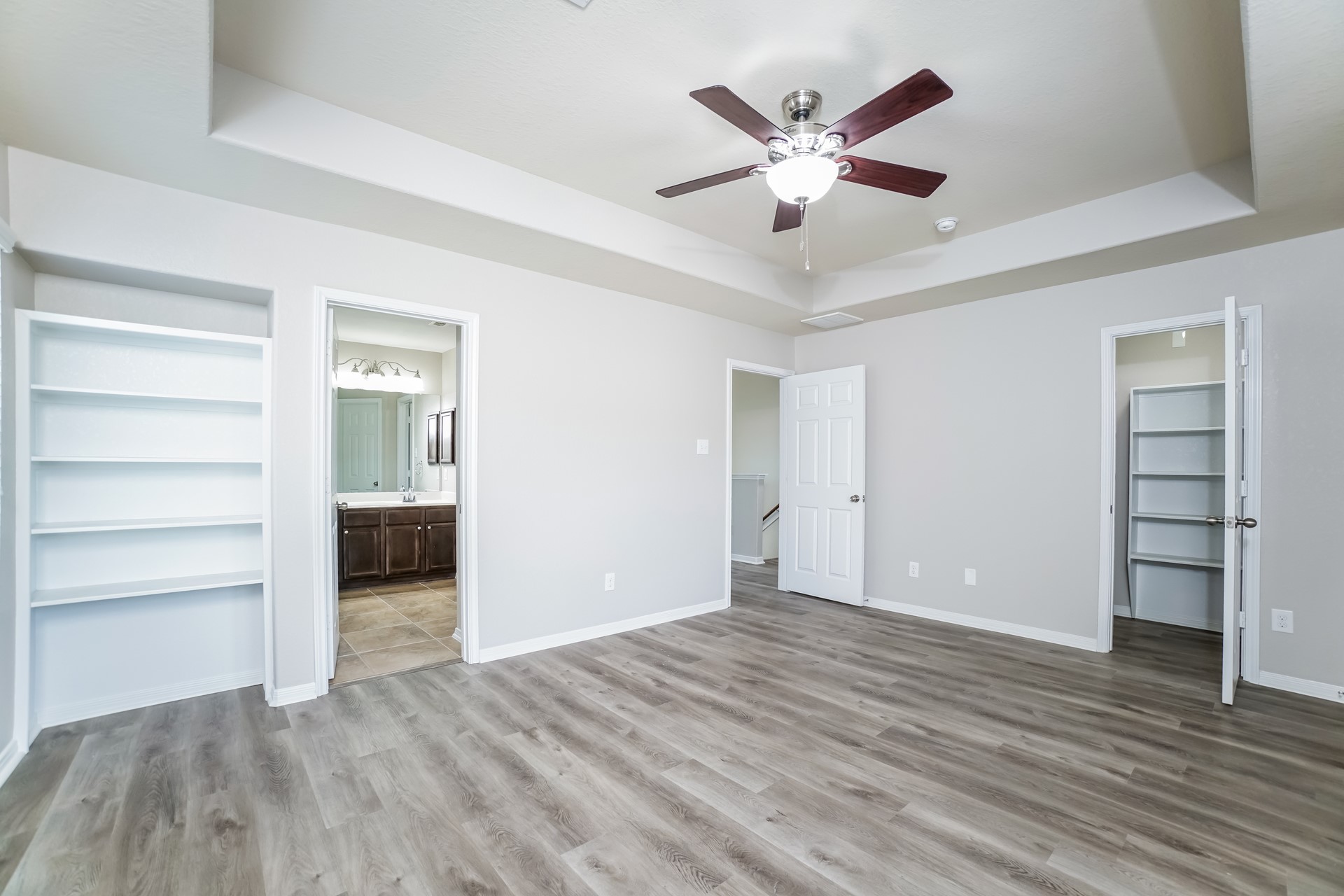 2694 Elm Crossing Trail Spring, TX 77386 - Photo 11 of 17 a view of an empty room with a ceiling fan and wooden floor