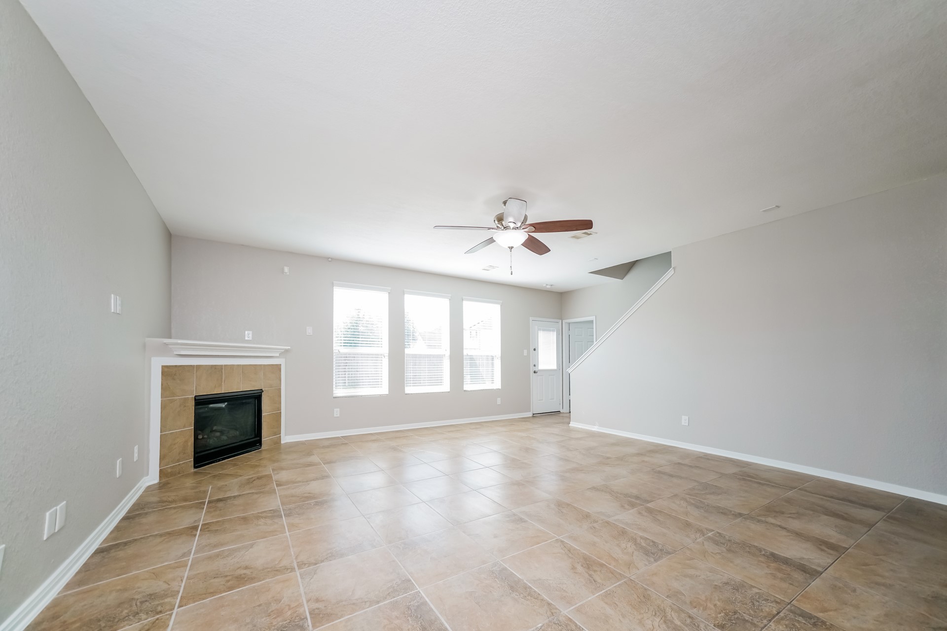 2694 Elm Crossing Trail Spring, TX 77386 - Photo 4 of 17 a view of an empty room with a fireplace and a window