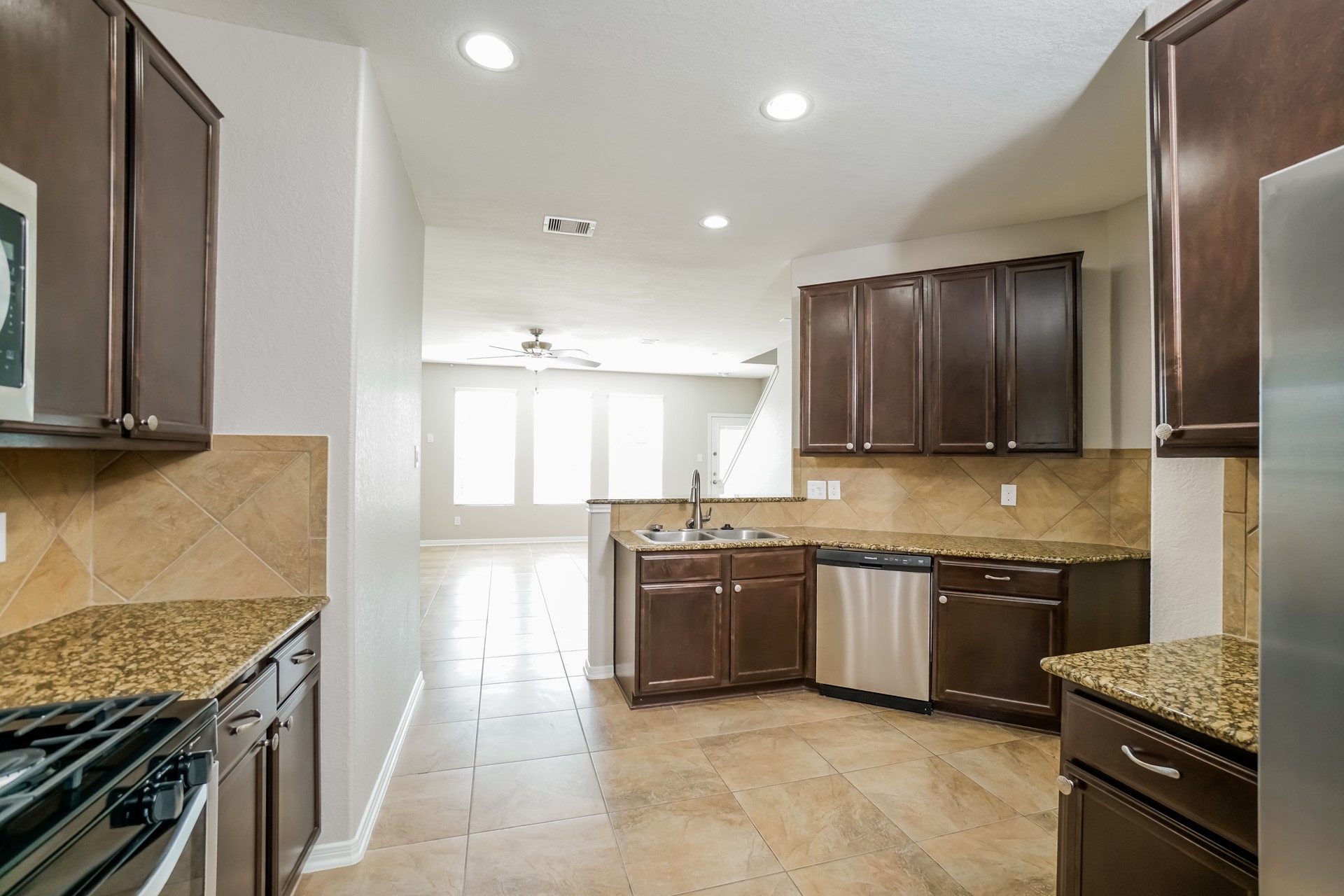 2694 Elm Crossing Trail Spring, TX 77386 - Photo 7 of 17 a kitchen with stainless steel appliances granite countertop a sink and a stove