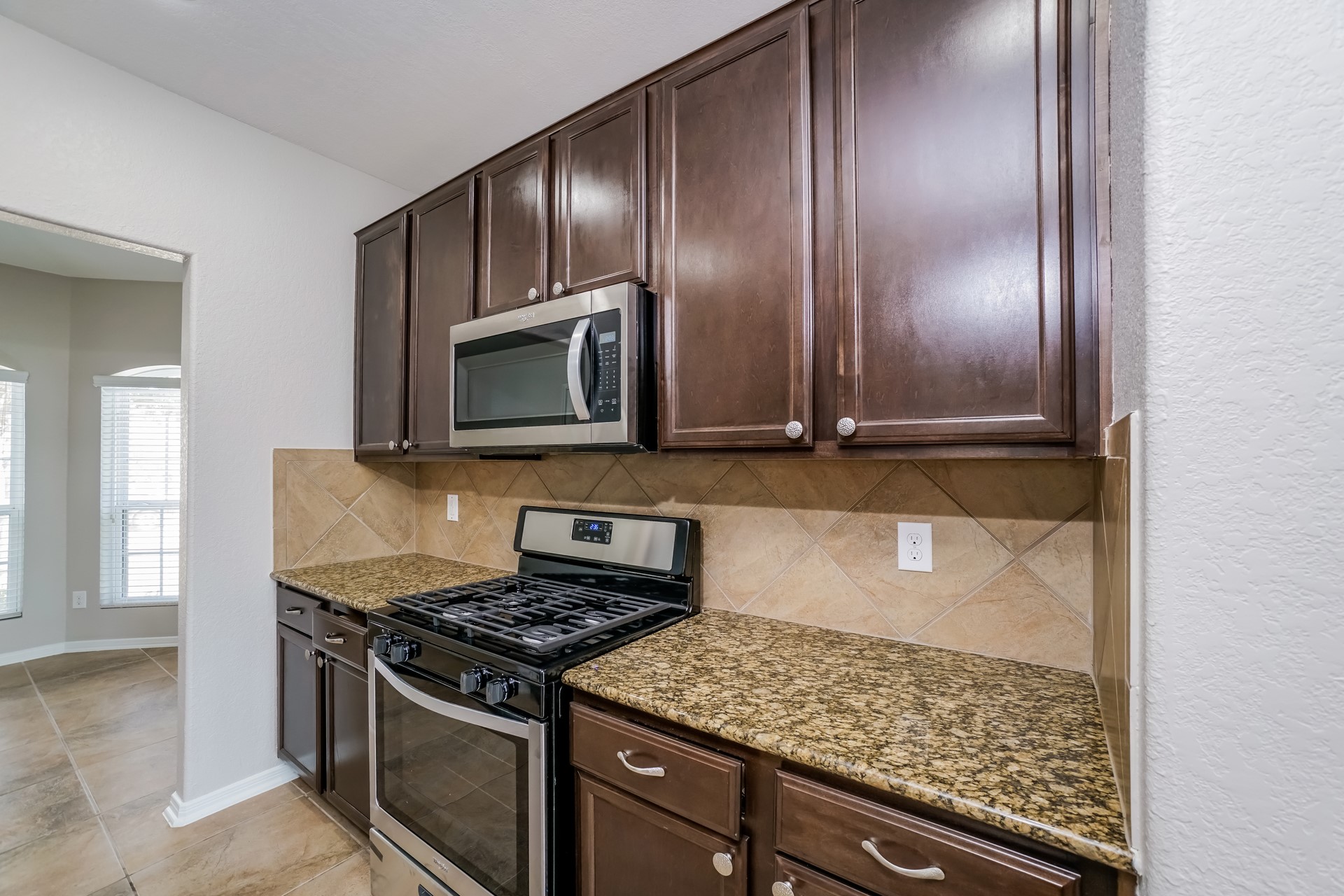 2694 Elm Crossing Trail Spring, TX 77386 - Photo 8 of 17 a kitchen with granite countertop stainless steel appliances and cabinets